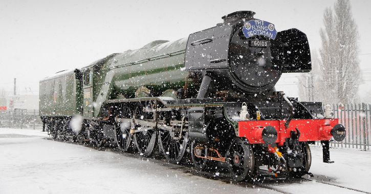 The Flying Scotsman steam engine surrounded by white bright snow